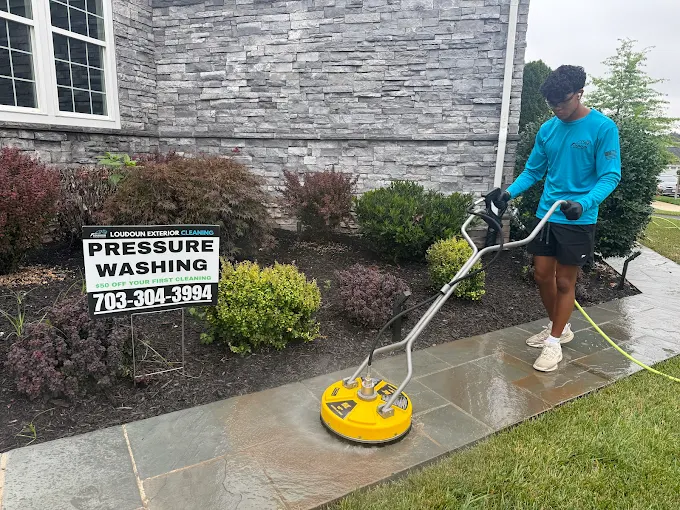Surface cleaner pressure washing a concrete driveway in Loudoun County