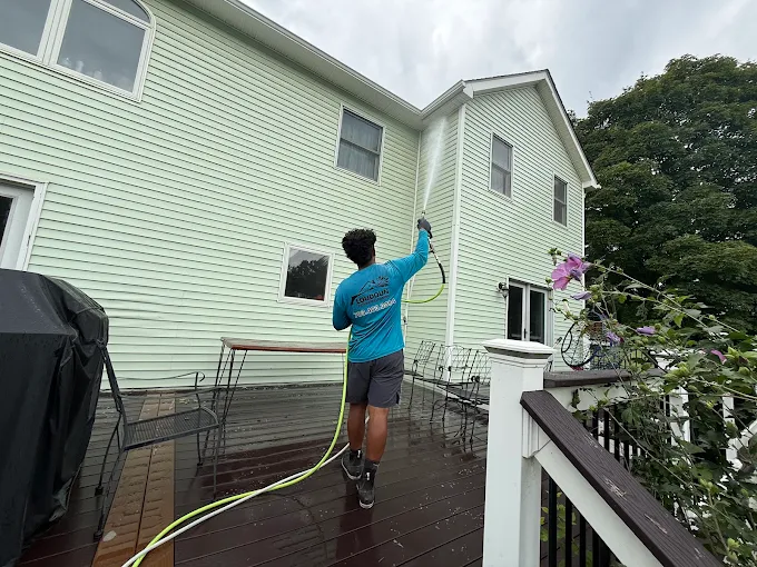 Loudoun Exterior Cleaning technician soft washing a home's siding