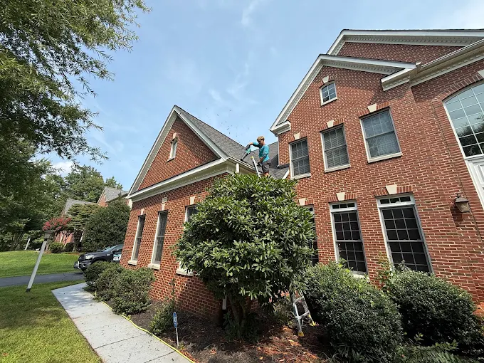 Loudoun Exterior Cleaning technician cleaning gutters on a Loudoun County home