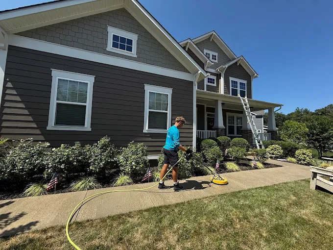 Owner surface cleaning a concrete patio