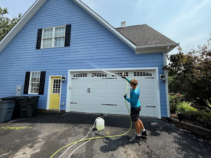 Soft washing blue vinyl siding on a Northern Virginia home