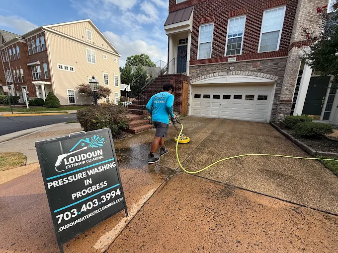 Technician cleaning concrete with a professional surface cleaner