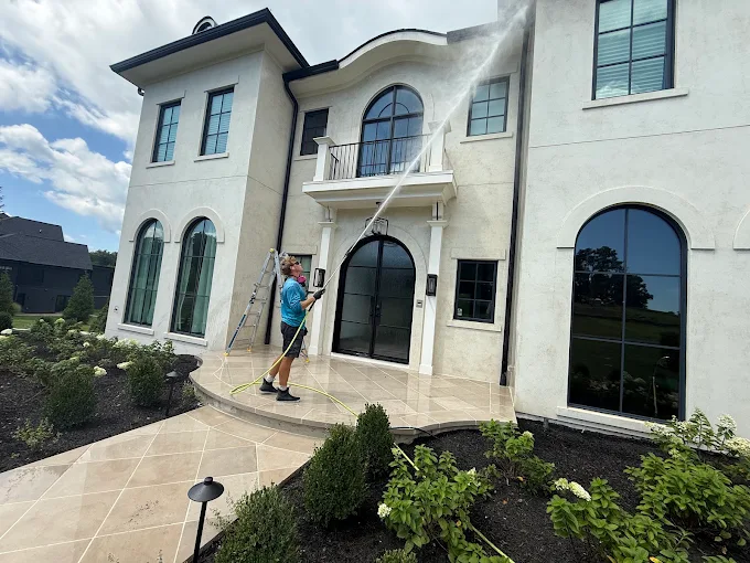 Owner of Loudoun Exterior Cleaning cleaning a home exterior