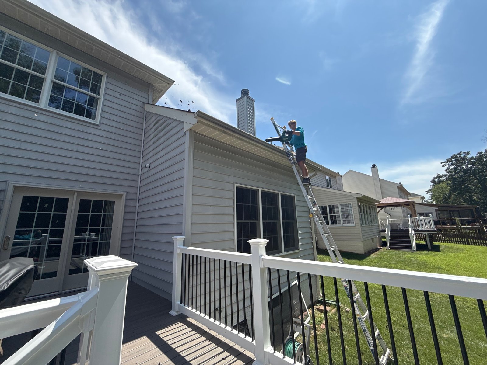 Gutter clean-out on a tree-shaded Loudoun County home