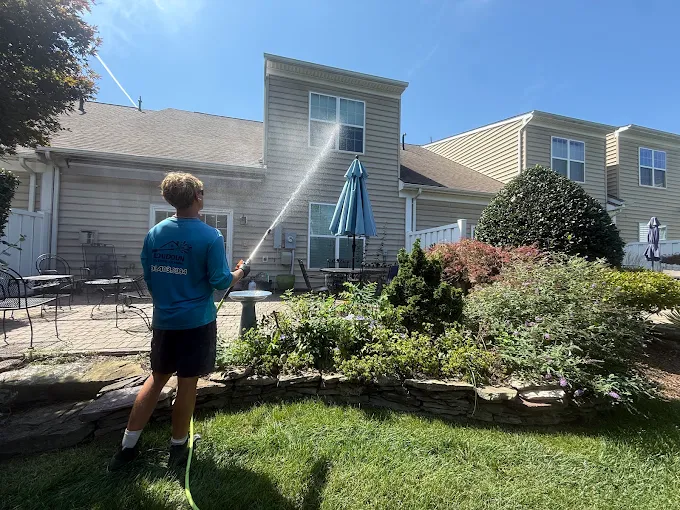 Owner of Loudoun Exterior Cleaning soft washing a home exterior
