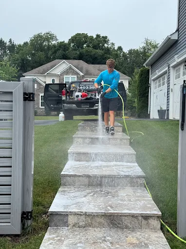 Rinsing exterior stairs after cleaning a Loudoun County home