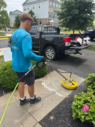 Owner surface cleaning a concrete driveway